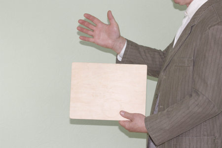 Business concept. The man in the jacket holds an empty plate. Photo for your designの写真素材