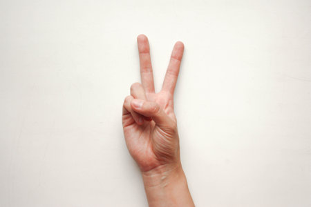 Victory concept. A female hand shows a sign of freedom. Photo for your designの写真素材