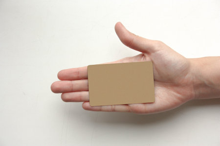Bank concept. A female hand holds a plastic gold card. Photo for your designの写真素材