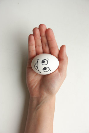 Diet and nutrition concept. The egg is fresh with a funny face with its tongue sticking out. hunger. Photo for your designの写真素材