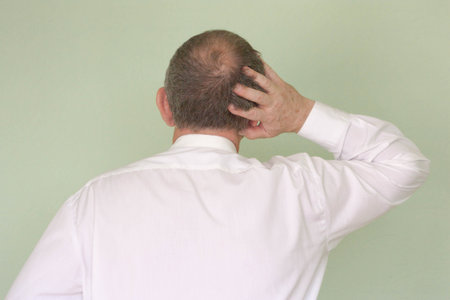 Business training concept. Photo for your design. A man stands with his back and scratches his headの写真素材