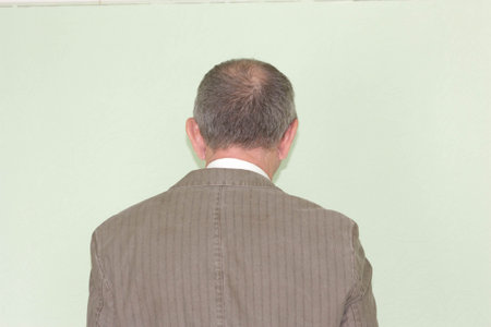 Business training concept. Photo for your design. The man is standing with his back. Looks into the distanceの写真素材
