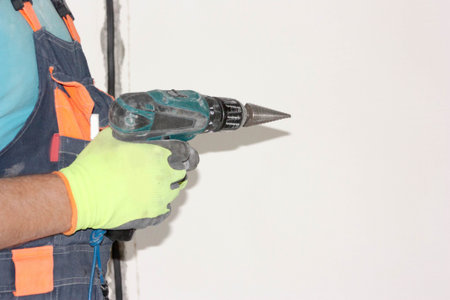 Construction concept. An electrician holds a screwdriver with a tip. Horizontal sheet orientationの写真素材