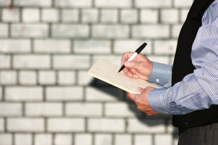 Business concept. The man writes a marker on the sheet. Photo for your design.の写真素材
