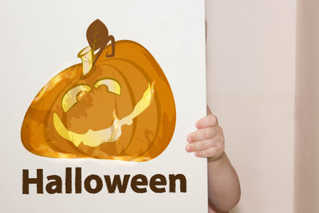 Halloween. a bright pumpkin funny with an inscription halloween. smiling. the child hides in the closetの写真素材