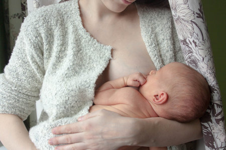 childhood concept. Horizontal orientation of the leaf. mom and baby at the breastの写真素材