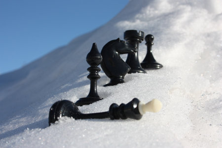 chess pieces are black in a white snowdrift. photo for your designの写真素材