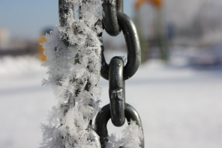 winter. snowflakes on the chain links. photo for your designの写真素材