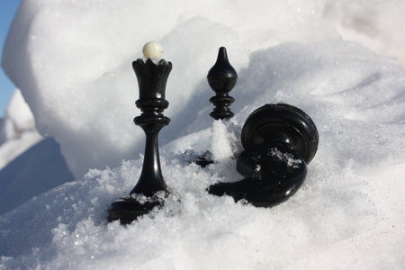 political struggle concept. chess pieces in the snow. photo for your designの写真素材