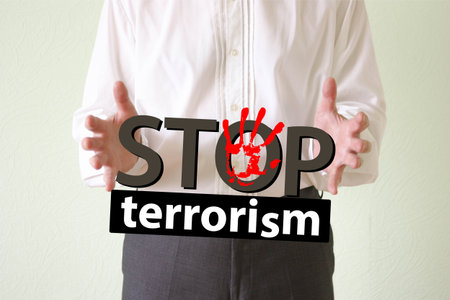stop terrorism concept. man holds the inscription in his handsの写真素材