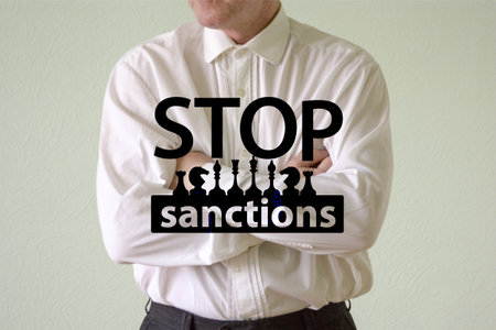 stop sanctions concept. a man in a white shirt folded his arms over his chestの写真素材