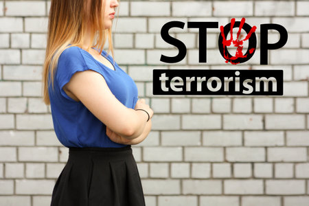 stop terrorism concept. girl on a brick wall background. hands in the boltの写真素材