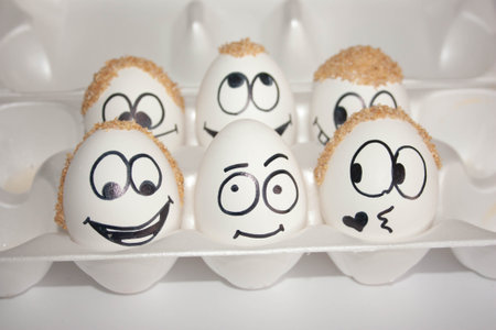 baldness problem concept. the egg is ashamed of its bald head. the eggs are funny and cute. photo with painted face on the shell. satire and comedy. eggs with hair on headの写真素材