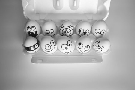 hostel concept. the eggs are funny and cute. photo with painted face on the shell. satire and comedy.の写真素材