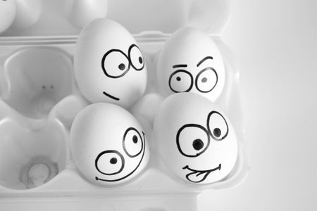 best friends concept. vacation with friends. the eggs are funny and cute. photo with painted face on the shell. satire and comedy.の写真素材