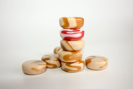 candy caramel. a pyramid of sweets. round. spiral to twist. photo for your design. dairy and strawberryの写真素材
