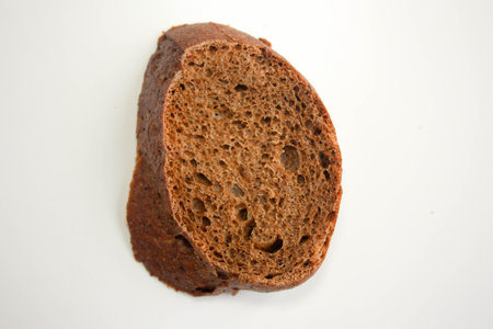bread black tasty slice on a white background. photo for your design. fresh breadの写真素材