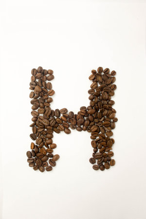 H the letter. alphabet of coffee. coffee beans. concept of healthy eating. photo for your design. vertical orientation of the sheetの写真素材