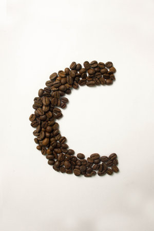C the letter. alphabet of coffee. coffee beans. concept of healthy eating. photo for your design. vertical orientation of the sheetの写真素材