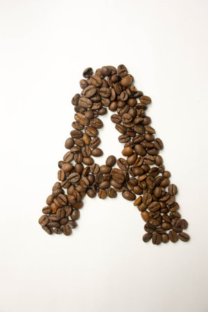 A the letter. alphabet of coffee. coffee beans. concept of healthy eating. photo for your design. vertical orientation of the sheetの写真素材