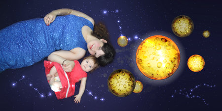 Mom and baby. A loving song before bedtime. children's dreams. distant planets and space. concept of...