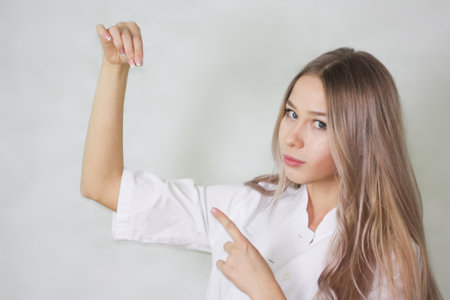 shugaring girl beautician. shows his index finger. on a white backgroundの写真素材