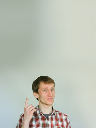 pointer. shows thumb concept. man handsome. holds in hands. with a place under the textの写真素材