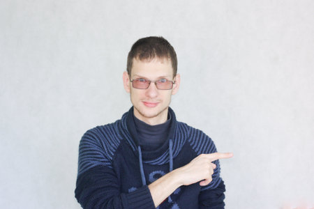 education. direction concept. the man is attractive with glasses the student shows his hand to the...