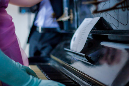pianoforte. playing the piano on notes. lady in a blue dress. hands in aristocratic glovesの写真素材