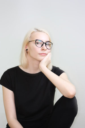 think concept. Girl in glasses. portrait on white background.blank in black.の写真素材