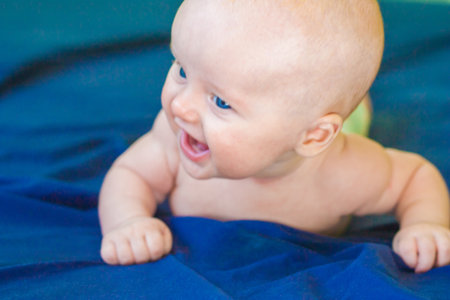 happiness is childish. baby is attractive and cute with big inviting blue eyesの写真素材