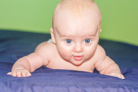the boy is strong and strong. baby is attractive and cute with big blue eyesの写真素材