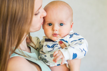 the baby is cute and sympathetic. Mother and son. portrait on white backgroundの写真素材