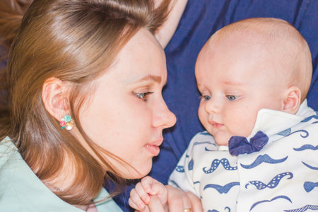 mother's kiss. mom kisses the baby. happiness is family. very similar. snub nose