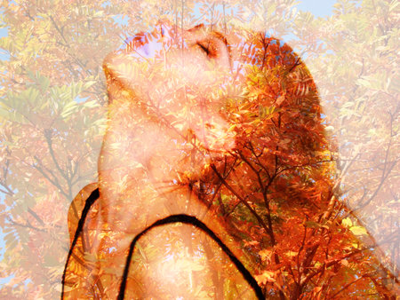 autumn breeze and rain concept. beautiful girl and a tree autumn. red-haired beauty. among the...