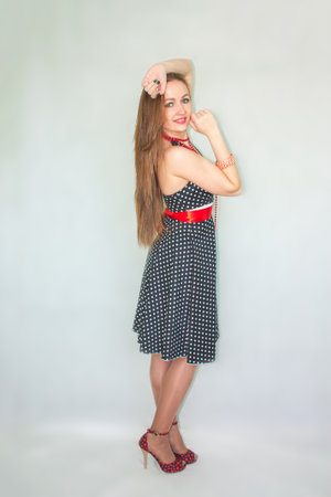 girl sexy retro. girl in full growth on a white background in profile. bewitching smile. high heelsの写真素材