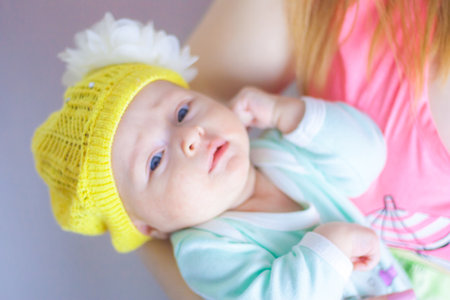 baby. proper nutrition of the child. girl in a hat with a bowの写真素材