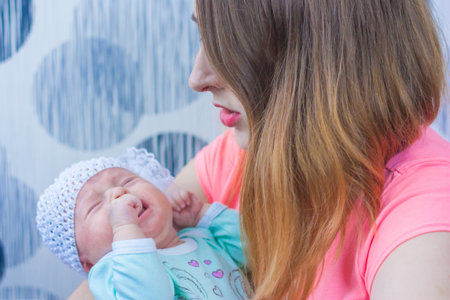 care for a newborn baby. girl in a hat with a bow. horizontal orientation