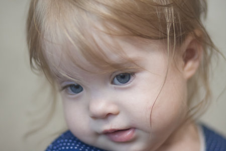 shyness baby concept.small girl portrait with big blue eyes