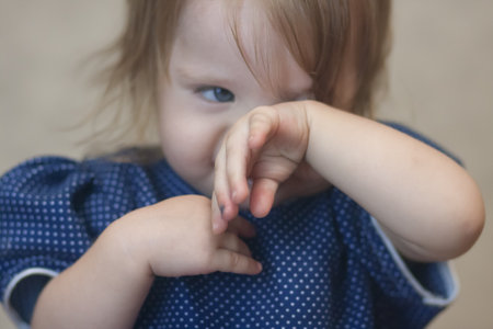 violence over child concept. little girl portrait with big blue eyes cryingの写真素材