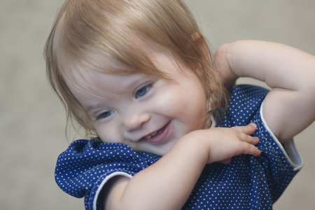 playful girl. little child in the game. blue-eyed little girlの写真素材