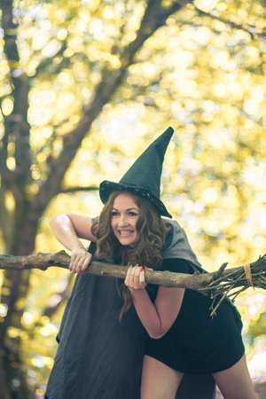 sorceress in halloween. portrait vertical. against the background of the autumn forestの写真素材