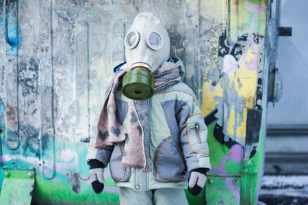 nuclear winter. a small child in a gas mask from a chemical attack. chemical protection maskの写真素材