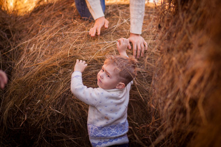 escape from fire hazard. the child runs away from inflammation. little baby and mother's hands. horizontal orientation of the photo. saved baby.の写真素材