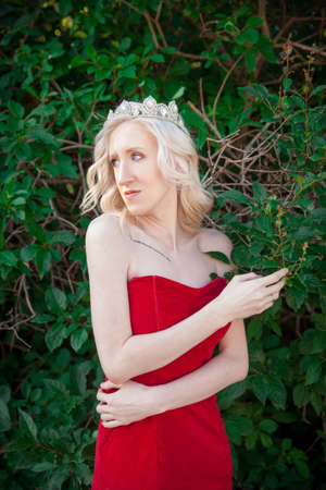 Beautiful girl with a crown on her head. Queen of beauty. Eve in the Garden of Edenの写真素材