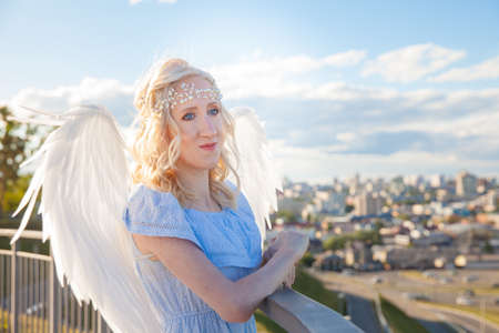 Angel girl with large white feather wings