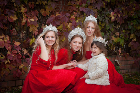 Russian girls are beautiful. Russian national traditions. Sisters in crowns. Wives from abroad. Girlfriends in red dresses. Fairy princesses.の写真素材
