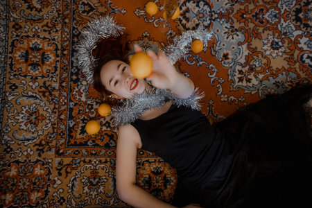 Festive composition with fruits, cheerful expression, warm vintage colors, cozy home atmosphere, overhead angle, creative seasonal portrait, joyful celebration vibe.の写真素材