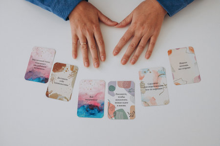 Flat layout shows multiple affirmation cards placed in gentle arc across bright white surface....