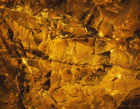 Rock pile. Stone texture. Gold texture. Golden Ore rocks. Stone background. Abstract texture.Structure. Shimmering surface. Precious Foil. Rough structure mineral. Rock texture.の写真素材